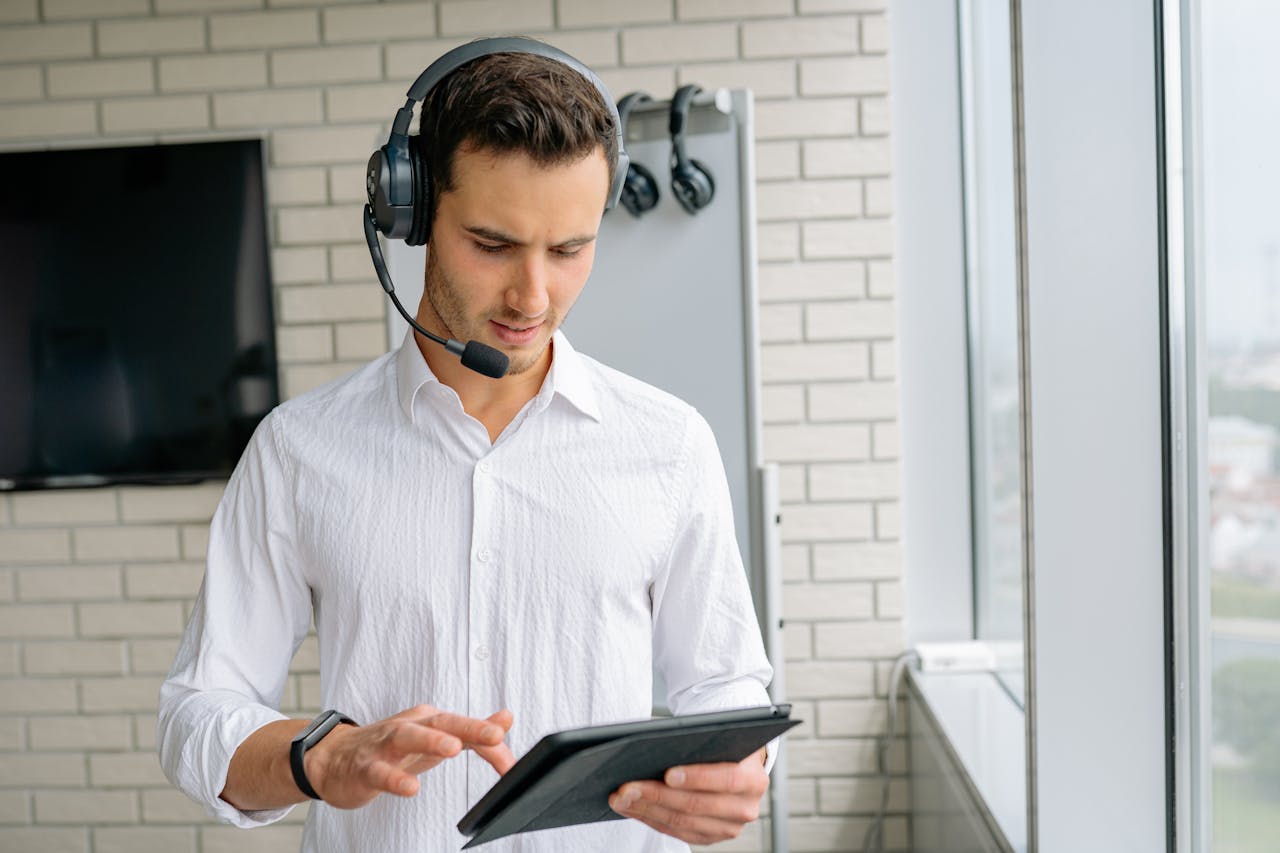 Man in White Long Sleeves Wearing Black Headset